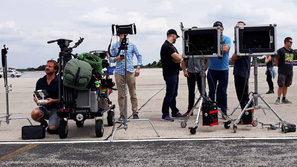 crew on outdoor set with monitors